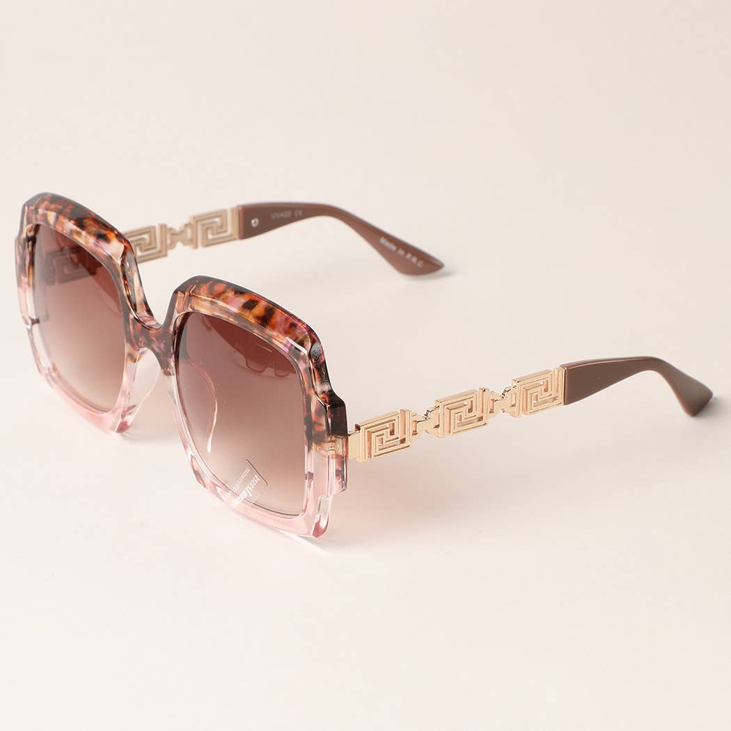 Sunglasses with tortoiseshell frame and gold accents on a light background