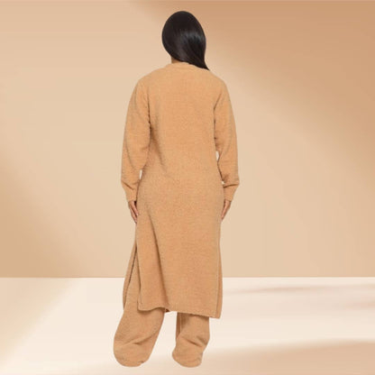 Person wearing a long beige coat on a beige background