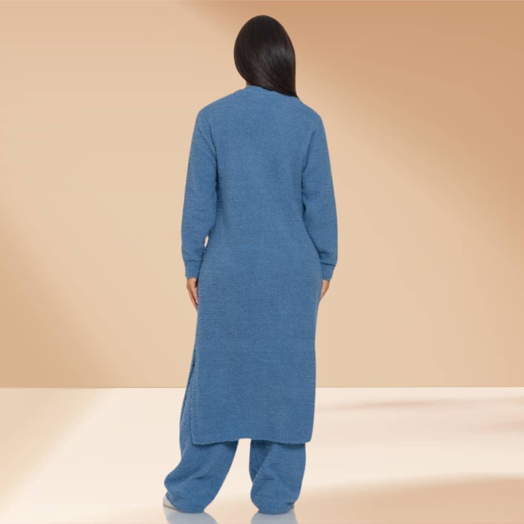 Woman wearing blue 3-piece teddy lounge set with long cardigan and wide-leg pants.
