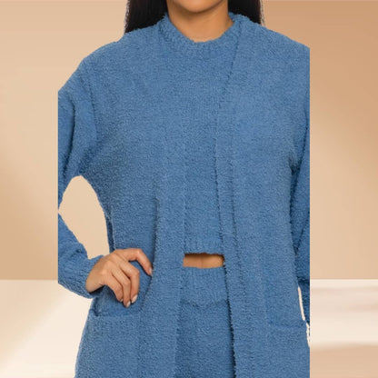 Blue textured outfit worn by a person on a beige background